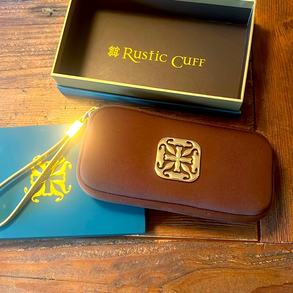 Rustic Cuff wristlet. New in box. Brown neoprene with gold strap, gold hardware